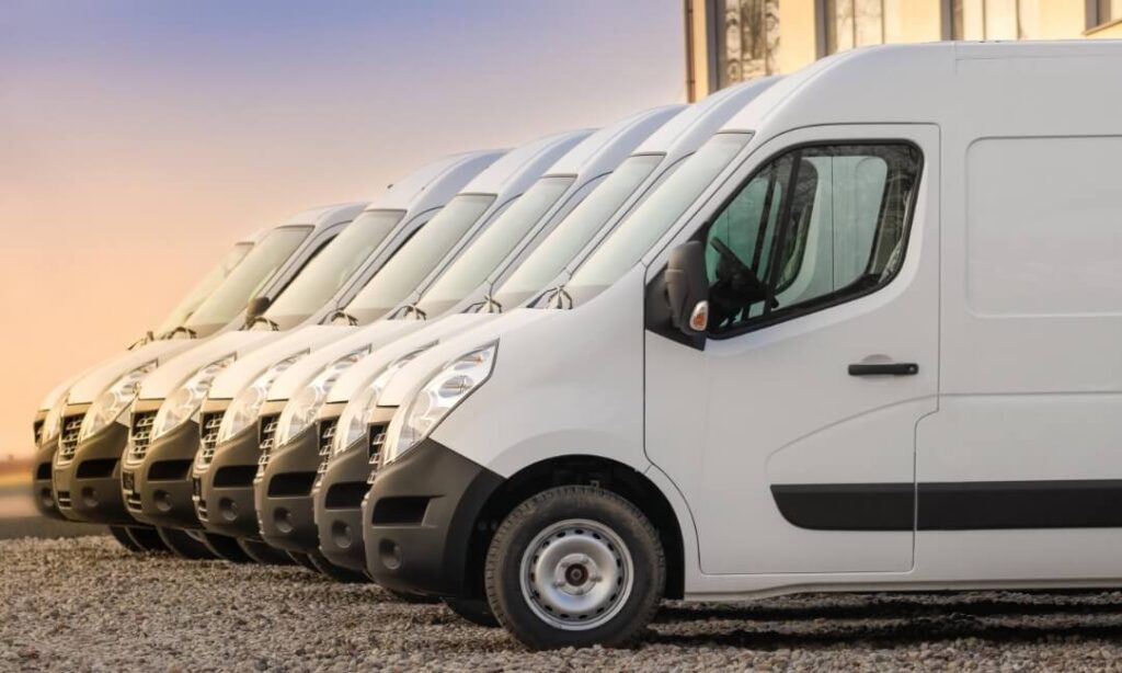 Fleet of white vans neatly parked next to each other