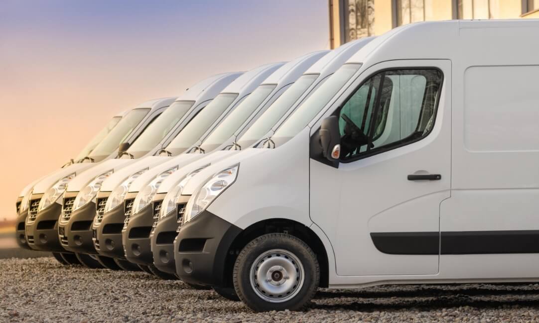 Fleet of white vans neatly parked next to each other