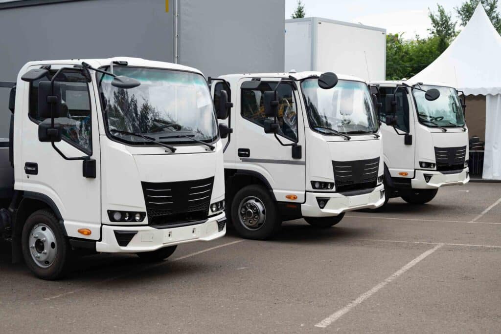 Fleet of white delivery trucks parked